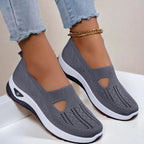 Model sitting wearing knit sandals, casual lifestyle shot