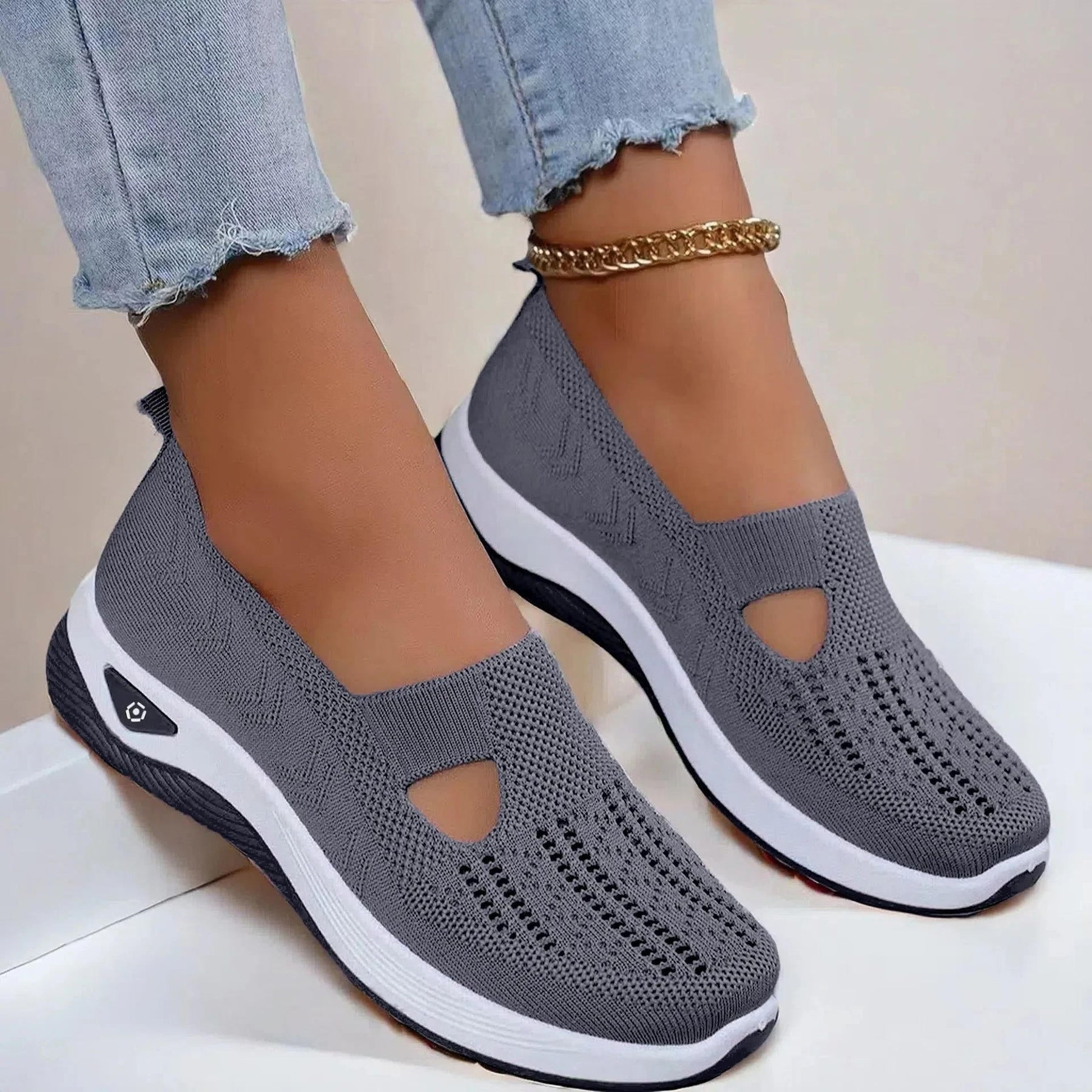 Model sitting wearing knit sandals, casual lifestyle shot