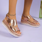 Model wearing sandals, seated pose highlighting platform sole