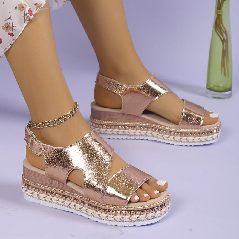 Model wearing metallic sandals, standing pose showing full shoe design