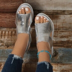 Alternative angle showing metallic sandals from above with foot positioning
