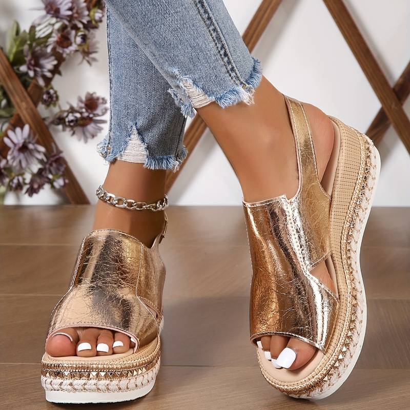 Model wearing metallic platform sandals, standing pose showing full silhouette