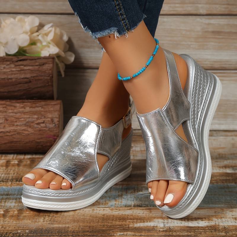 Women's silver metallic cut-out wedge platform sandals displayed on white background