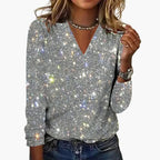 Women's sequin top with V-neckline and long sleeves displayed flat