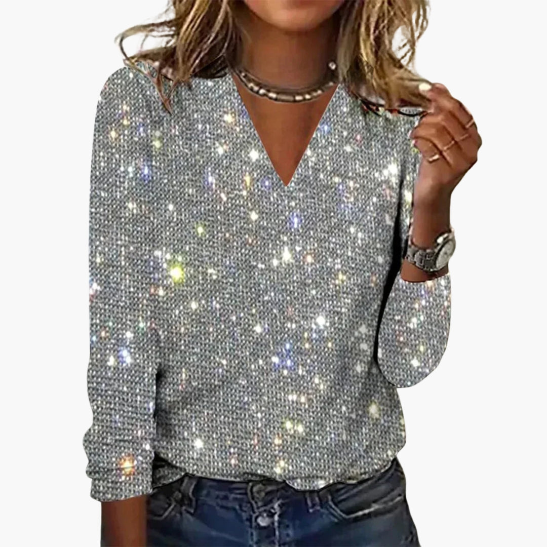 Women's sequin top with V-neckline and long sleeves displayed flat