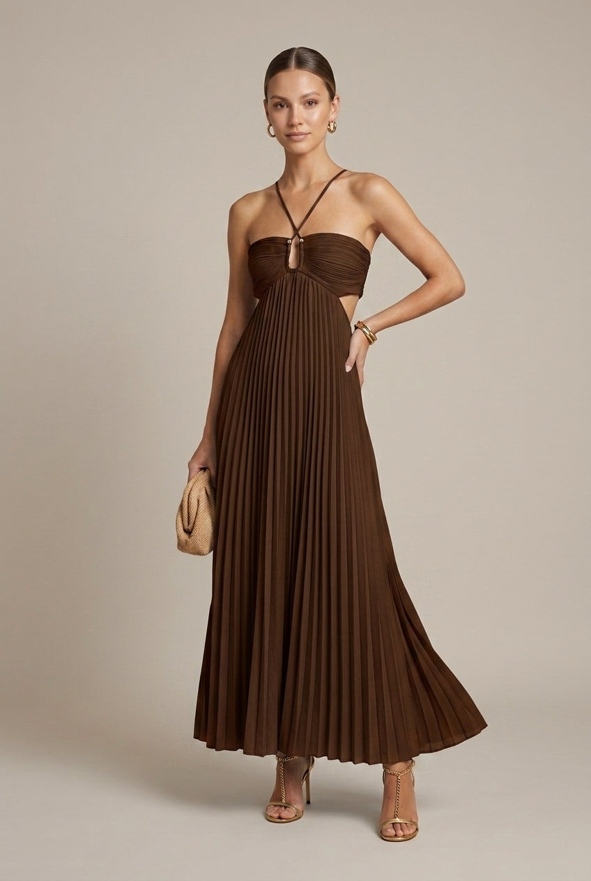 Model in pleated maxi dress walking, showcasing skirt movement