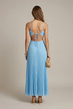 Model wearing pleated halter maxi dress, full-length side pose