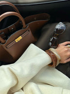 Flat lay of tan leather tote bag from above