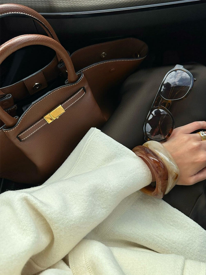 Flat lay of tan leather tote bag from above