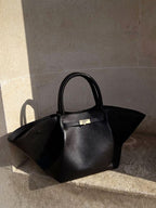 Woman with tote bag on arm, front facing pose