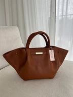 Tote bag held in hand, showing structured shape