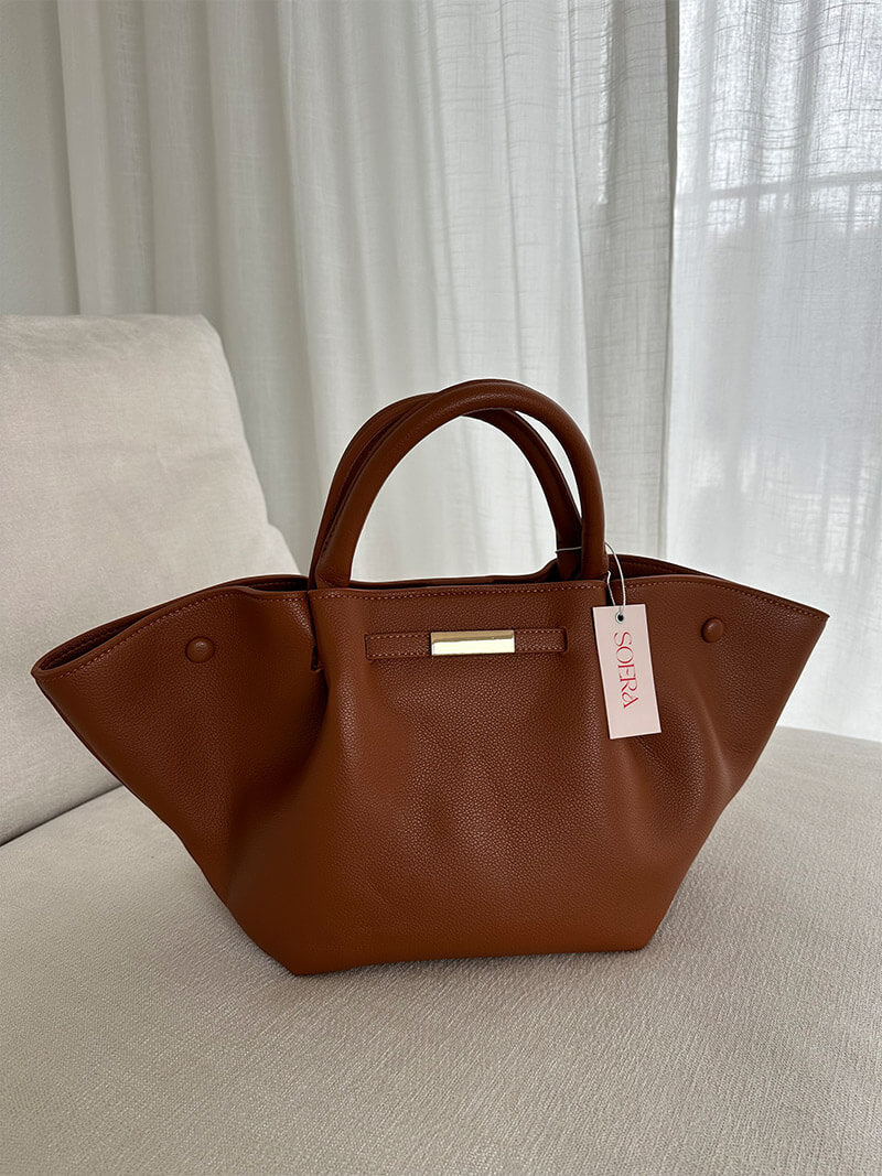 Tote bag held in hand, showing structured shape