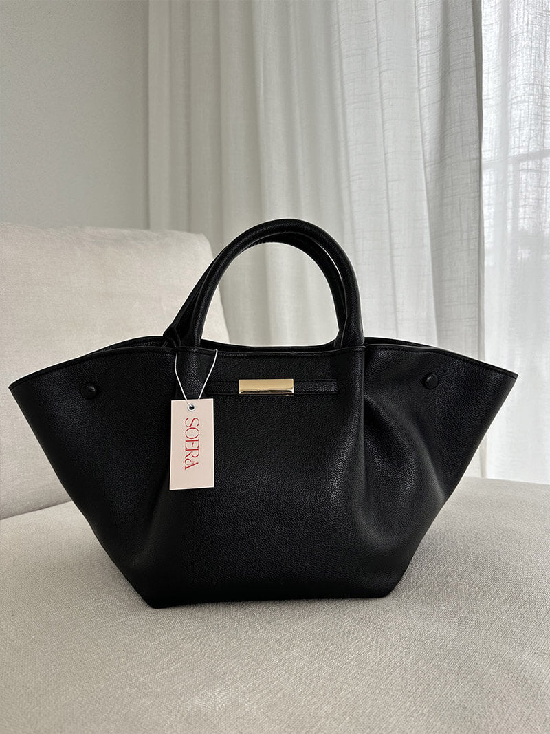 Woman carrying tote bag while walking, lifestyle shot