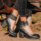 Side profile of ankle boots showing block heel and buckle strap detail