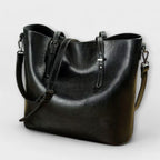 Woman carrying tan leather tote crossbody style, walking shot