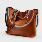 Tan brown leather tote bag with adjustable shoulder straps, front view