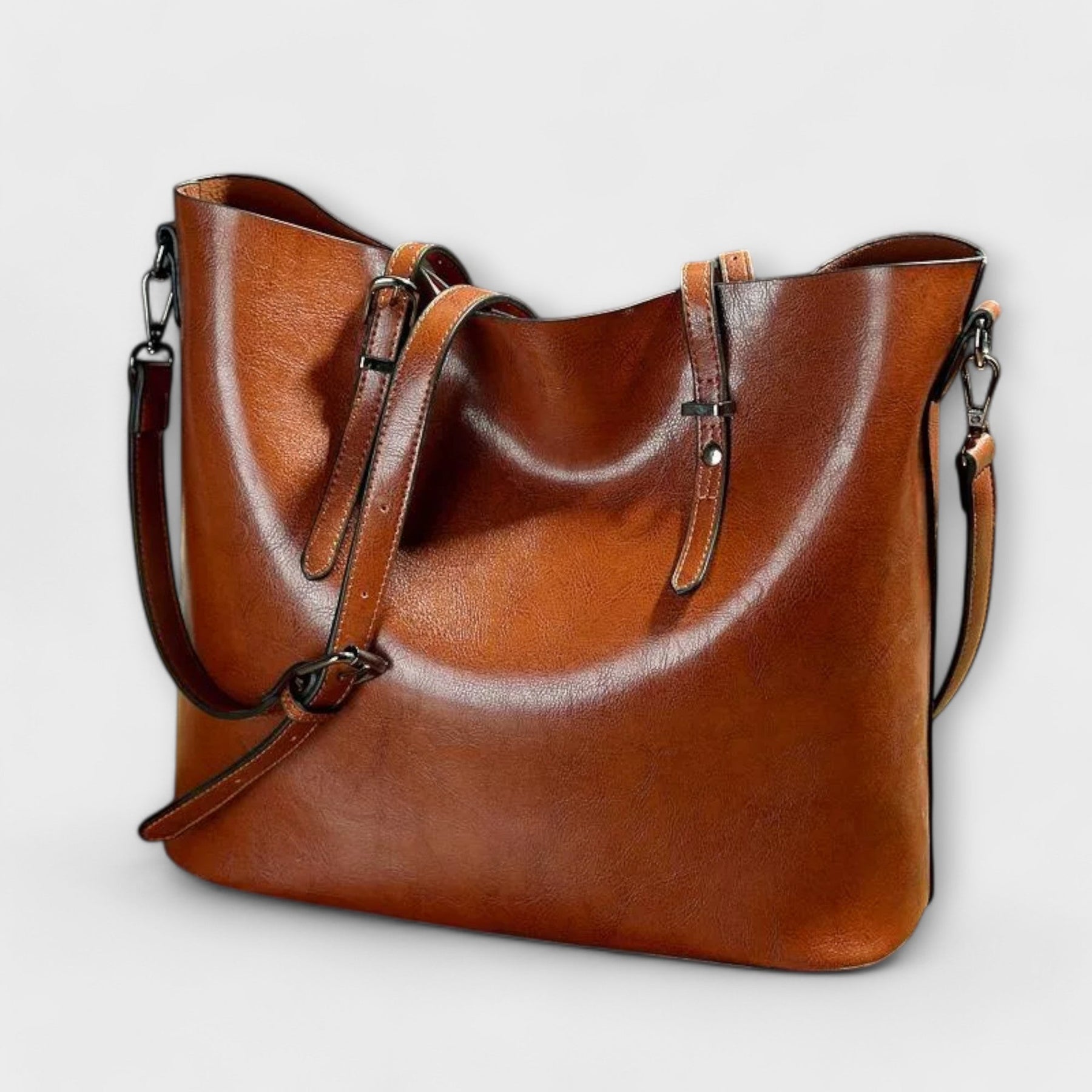 Tan brown leather tote bag with adjustable shoulder straps, front view