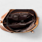 Close-up of tan leather texture and stitching detail