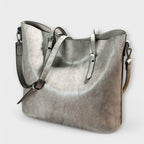 Tan leather tote bag positioned flat, overhead view