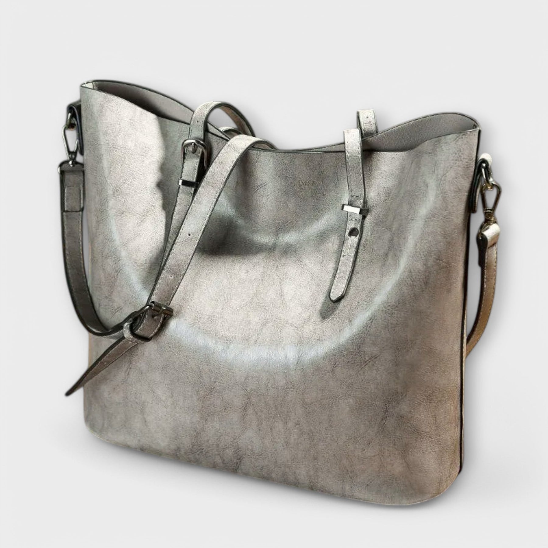 Tan leather tote bag positioned flat, overhead view