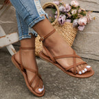 Tan sandals worn with a midi floral dress, side profile view