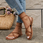 Woman walking in tan ankle strap sandals with casual white linen outfit