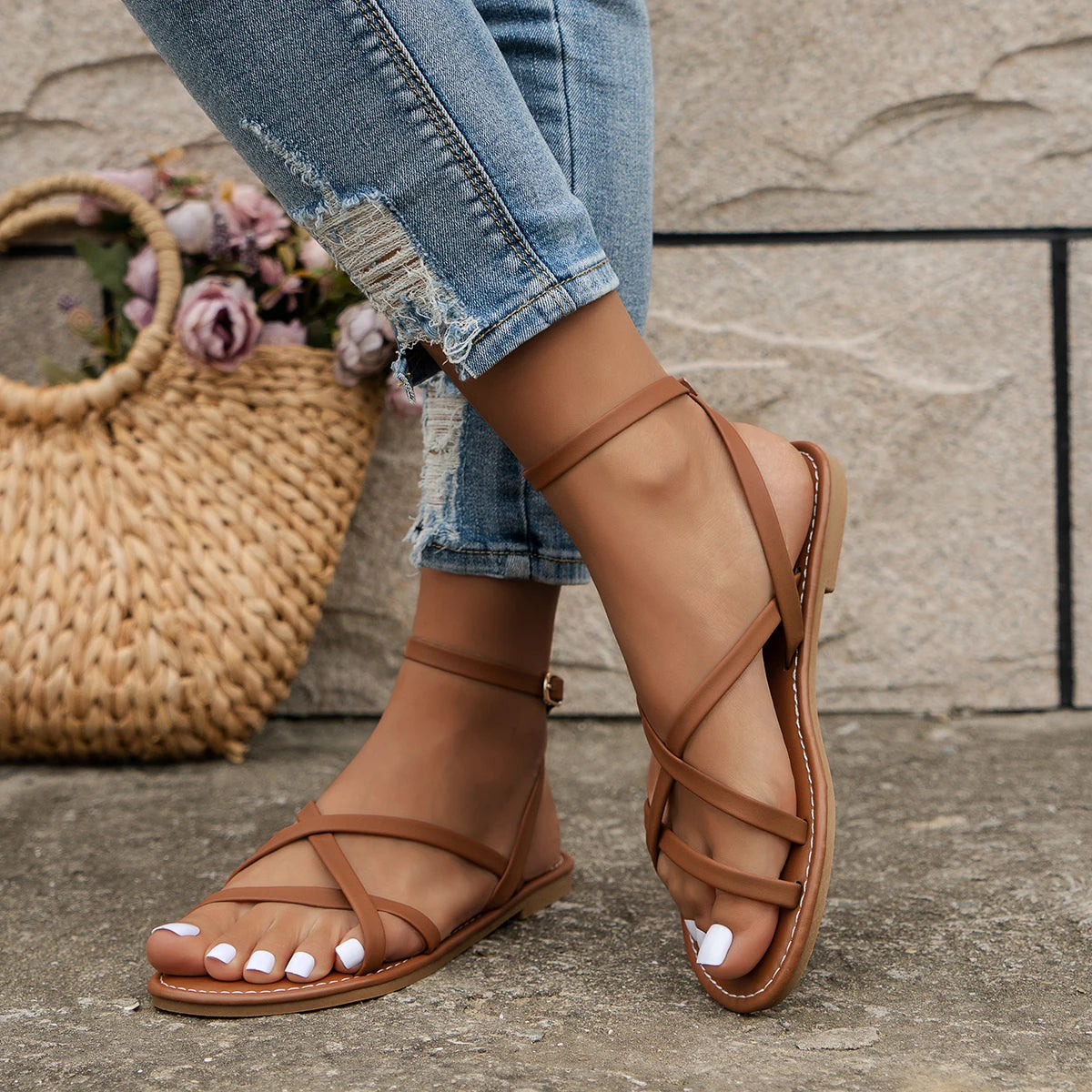 Woman walking in tan ankle strap sandals with casual white linen outfit