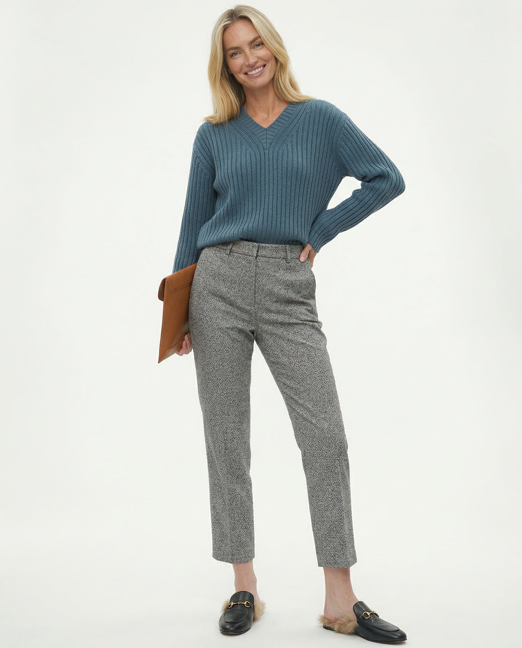 Model in neutral pose wearing trousers and heels