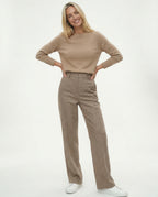 Model wearing wide leg trousers with fitted roll neck