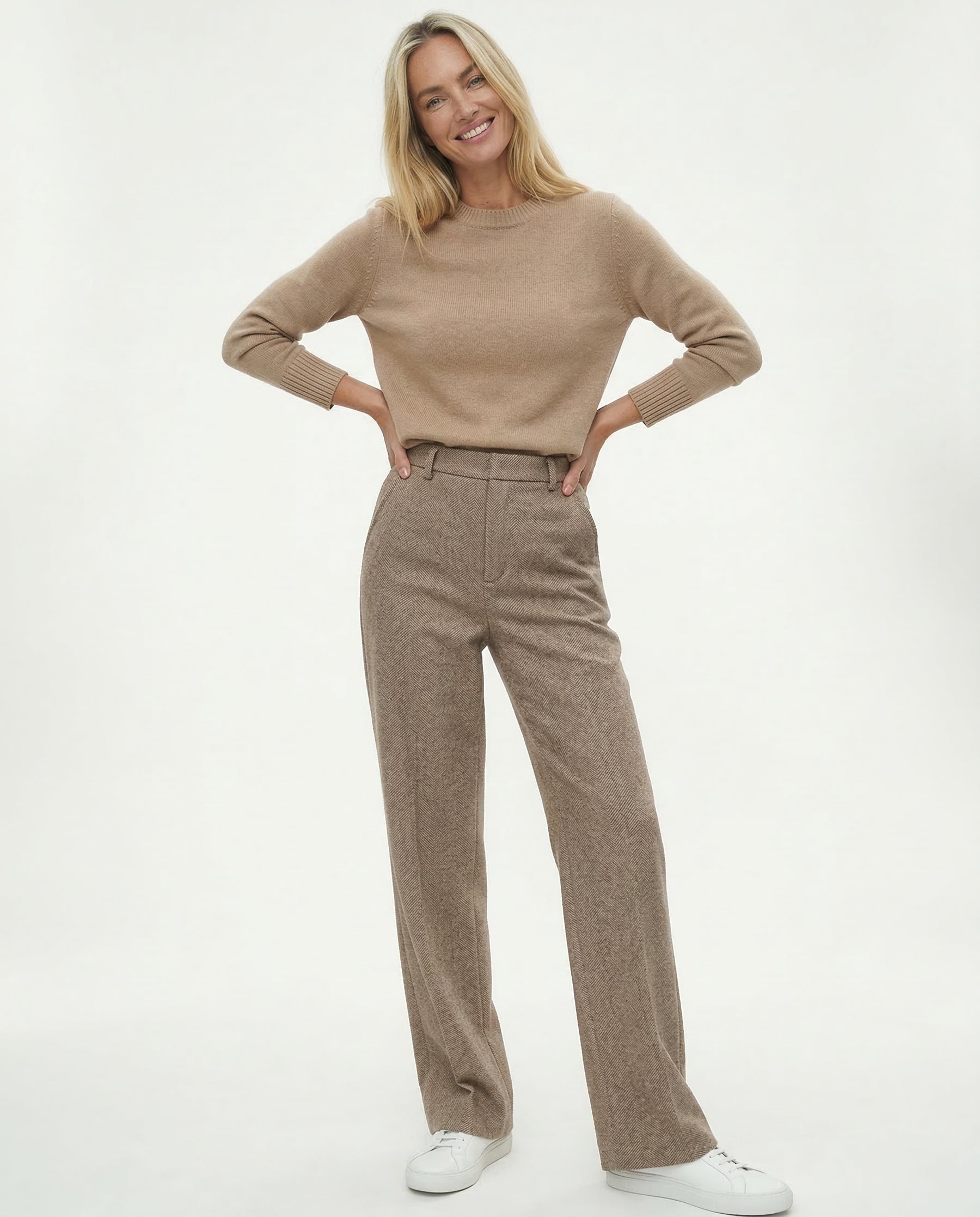 Model wearing wide leg trousers with fitted roll neck
