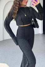 Back view highlighting the fit of the ribbed knit top and flare trousers