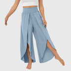 Model in teal trousers, standing with relaxed pose