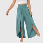 Model wearing teal trousers, side profile pose