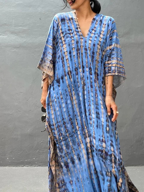 Model wearing tie dye caftan, full length side profile