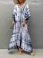Model in caftan, walking pose from side angle