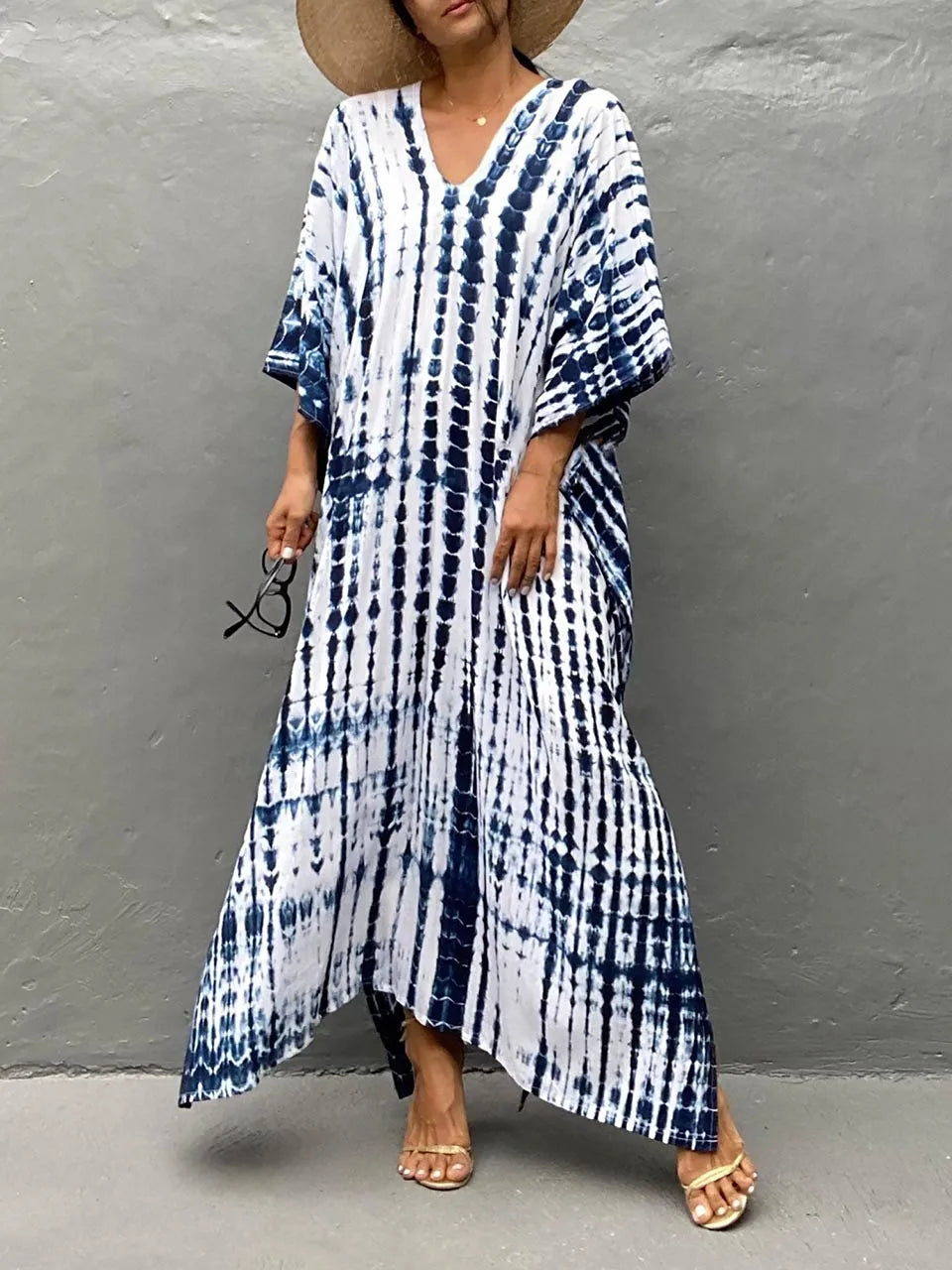 Model in caftan, walking pose from side angle