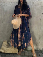 Model wearing caftan, seated pose showing drape