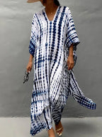 Model posing in caftan dress, three-quarter view
