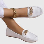 White chain loafers with gold embellishment, front view