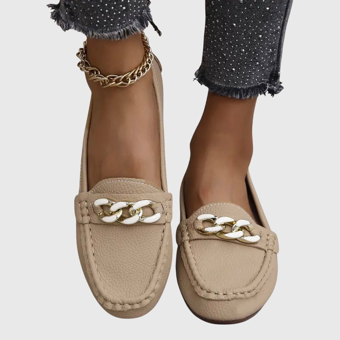 Close-up of gold chain detail across loafer vamp