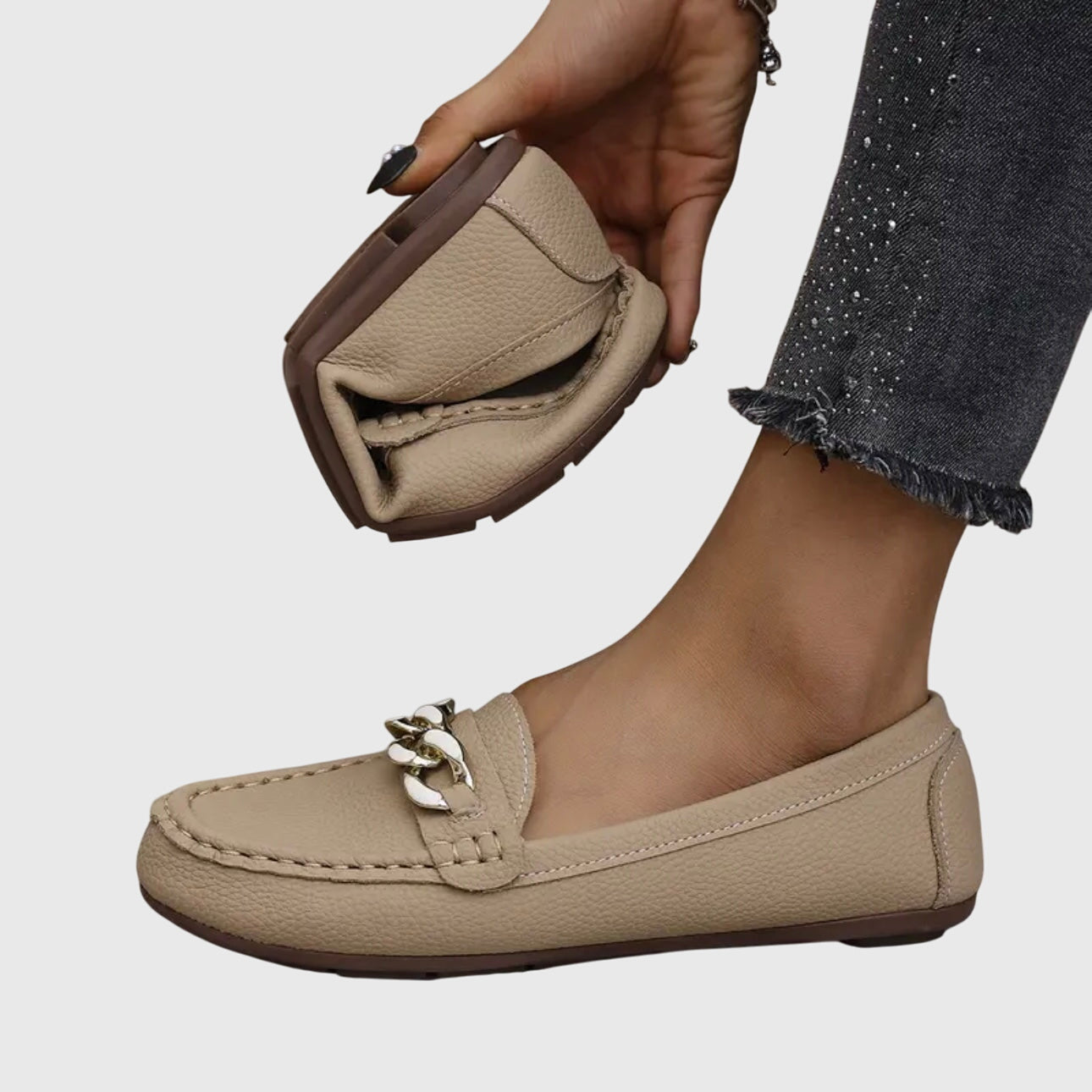Woman in casual outfit walking in white chain loafers