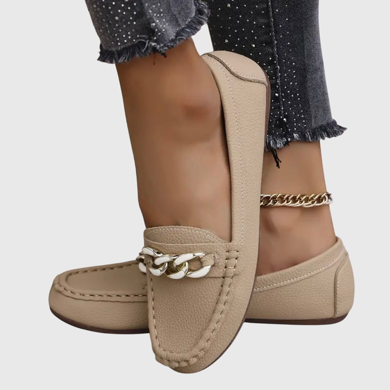 Woman wearing white chain loafers with trousers