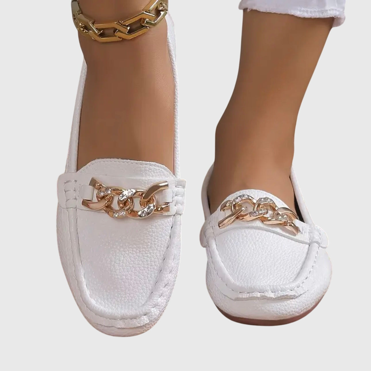 Three-quarter angle view of white chain loafer