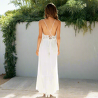 Woman wearing white maxi dress showing lace detailing at neckline and waist