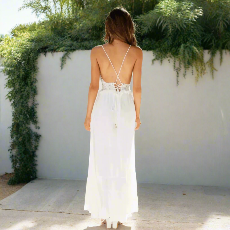 Woman wearing white maxi dress showing lace detailing at neckline and waist