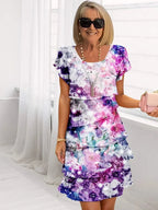 Side profile showing cascading ruffles and midi length