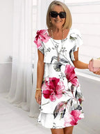 Woman wearing floral ruffled midi dress with white background