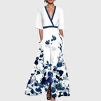 Women's white maxi dress with blue floral print and V-neckline, full-length front view