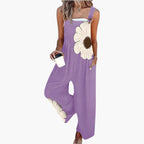 Model in casual pose wearing floral jumpsuit, three-quarter view