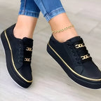 Close-up of gold chain embellishment on trainer upper